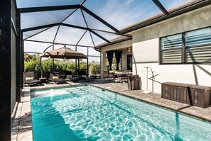 A swimming pool with a covered patio area, outdoor furniture, and a view of the surrounding landscape. - 635 4 Large Bedrooms Private Pool Game Room (Naples)