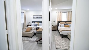A bedroom with two beds, a sofa, a desk, and a rug. - Good Vibes Oasis - Cozy Townhome With Parking (Cutler Bay)