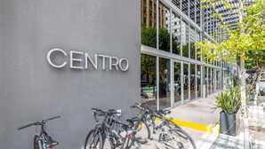 A building with a sign reading "CENTRO" and several bicycles parked outside.