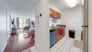 A modern kitchen with a dishwasher, a sink, and wooden cabinets. - Brickell Bay View- Unbeatable Location With Parking (Miami)