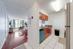 A modern kitchen with a dishwasher, a sink, and wooden cabinets. - Brickell Bay View- Unbeatable Location With Parking (Miami)