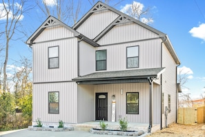 A two-story house with a front porch, a black front door, and a mailbox. - The Lookout (Clarksville)