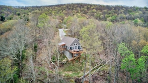 A house with a deck, surrounded by forest. - Lessons From Mars (Banner Elk)