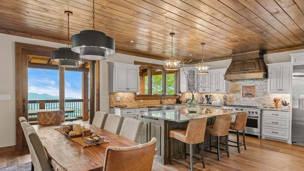 A spacious kitchen with a large island, wooden ceiling, and a view to the outdoors. - Amongst the Clouds at Chappell Farms (Banner Elk)