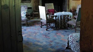 A room with a fireplace, a table with chairs, and a patterned carpet. - Chateau de Vermette: wedding, seminars, master class, long term rental possible (Argentonnay)