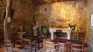 A stone-walled room with a wooden altar, benches, and a fresco. - Chateau de Vermette: wedding, seminars, master class, long term rental possible (Argentonnay)