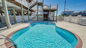 A swimming pool with a wooden deck, a staircase, and a white fence. - Surf City Stay - Motel Unit - Walk to Beach (Surf City)
