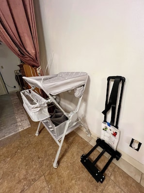 A room with a white ironing board, a black stand, and a small black object on the wall. - Condo • 2 Beds •1 ba near Downtown-Riverwalk, La cantera-Fiesta Texas, Sea World (San Antonio)