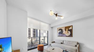 Condo, Balcony, City View | Living area | 36-inch Smart TV with cable channels