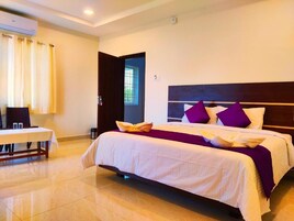 Una habitación de hotel con una cama, una mesa y una ventana.