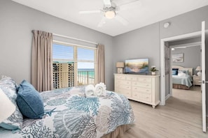 A bedroom with a bed, a dresser, a television, and a view of the outdoors. - Shore of Panama Unit 924,  BEACHFRONT 2 bd+Bunk, 3 bath, Sleeps 8 (Panama City Beach)