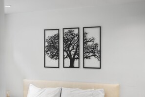 A wall with three framed black tree silhouettes.