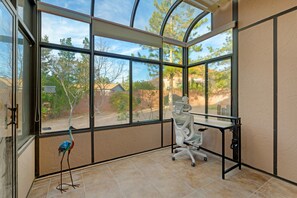 A room with a large glass window, a desk, and a chair. - Angel View: Charming 3-bedroom 3bath house near Chapel of the Holy Cross, Sedona (Sedona)