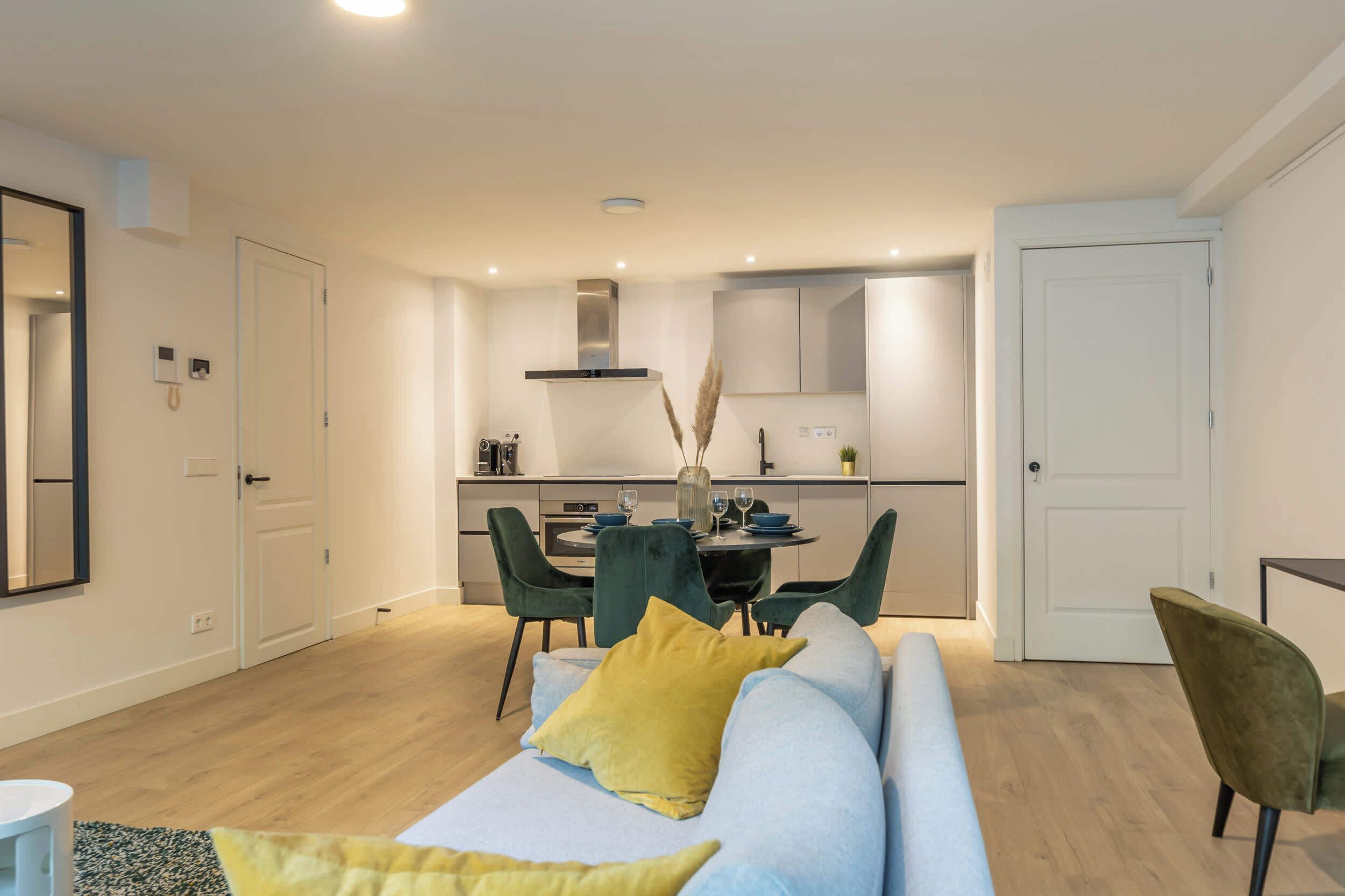 A modern apartment with a living area, dining space, and kitchen.