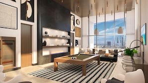 A modern living room with a pool table, seating area, and large windows offering a city view. - District 225 Downtown Miami (Miami)