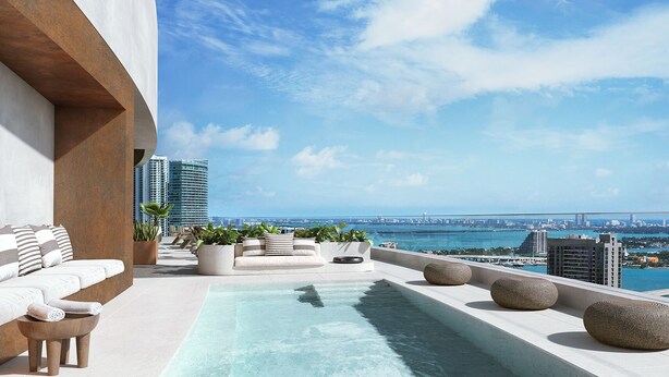 A rooftop pool with a city view, a seating area with cushions, and potted plants. - District 225 Downtown Miami (Miami)