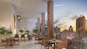 A modern restaurant with high ceilings, exposed beams, and a city skyline view. - District 225 Downtown Miami (Miami)