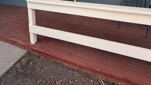 A house with a porch, a wooden door, and a window. - Cozy studio in beautiful Flagstaff with cool AC for your stay (Flagstaff)