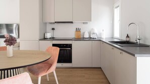 A modern kitchen with a dishwasher, a coffee maker, and a sink.