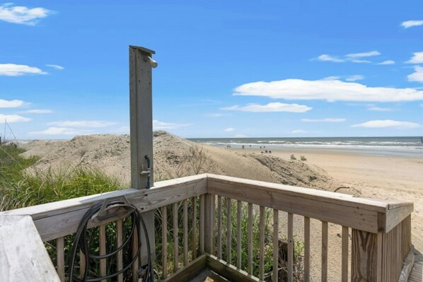 A wooden deck with a view of a sandy beach and ocean. - Sea Cabin 242- 2 Bedroom in Cherry Grove (North Myrtle Beach)