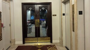 A hotel lobby with a chandelier, double doors, a carpet, and an exit sign. - 3.1 mi. to Lumen Field, World Cup; 1-bedroom hotel suites, sleeps 4 in Seattle (Seattle)
