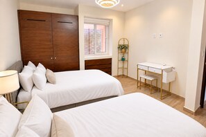 A bedroom with two beds, a desk, and a wardrobe. - Marina view 3BR pool 7min walk to beach (Puerto Aventuras)