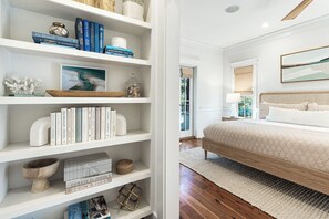 A bedroom with a bed, a bookshelf, and a window. - Newly Renovated Cottage on 30a - Fin and Tonic (Seacrest)