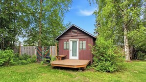 A small wooden cabin with a front porch, a door, and a window. - Cozy Anchorage Cabin, Full Kitchen & Deck (Anchorage)