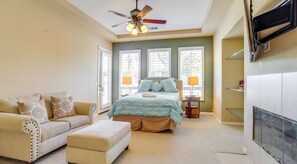 Bedroom with an upholstered loveseat, ottoman, fireplace, and shuttered windows. - Luxury La Quinta Retreat w/ Pool & Views (La Quinta)