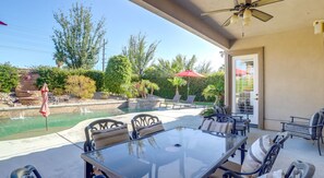 Covered patio with dining table overlooking a backyard swimming pool and hot tub. - Luxury La Quinta Retreat w/ Pool & Views (La Quinta)