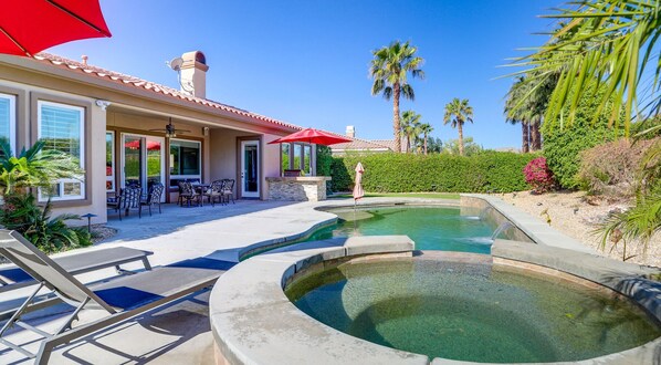 Backyard patio featuring a swimming pool, attached hot tub, and shaded dining areas. - Luxury La Quinta Retreat w/ Pool & Views (La Quinta)
