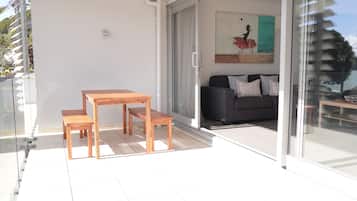 Deluxe Apartment, Balcony, Beach View | Outdoor dining