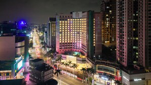 A high-rise hotel with multiple floors, a central courtyard, and surrounding urban buildings.