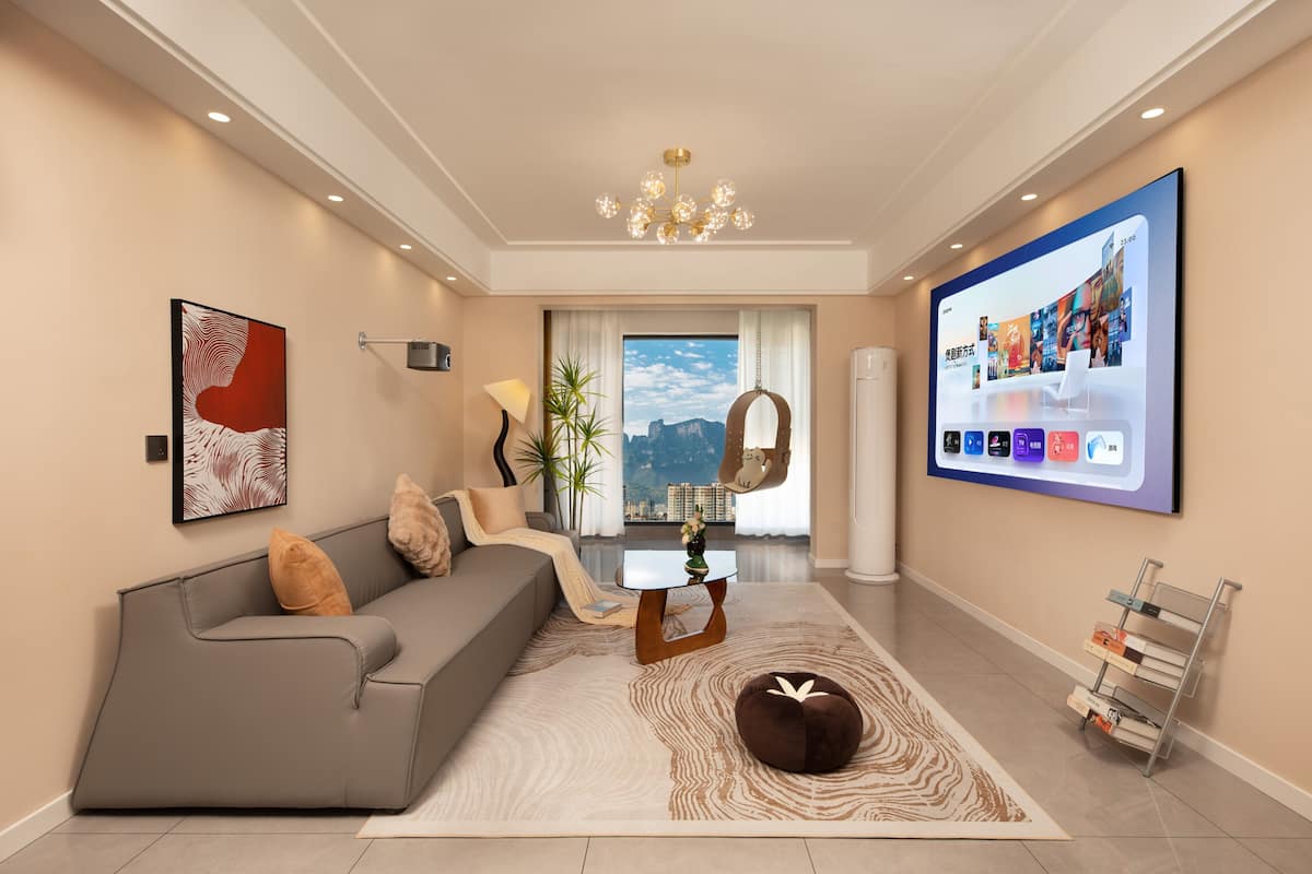 A modern living room with a sofa, coffee table, and a large TV screen displaying a menu.