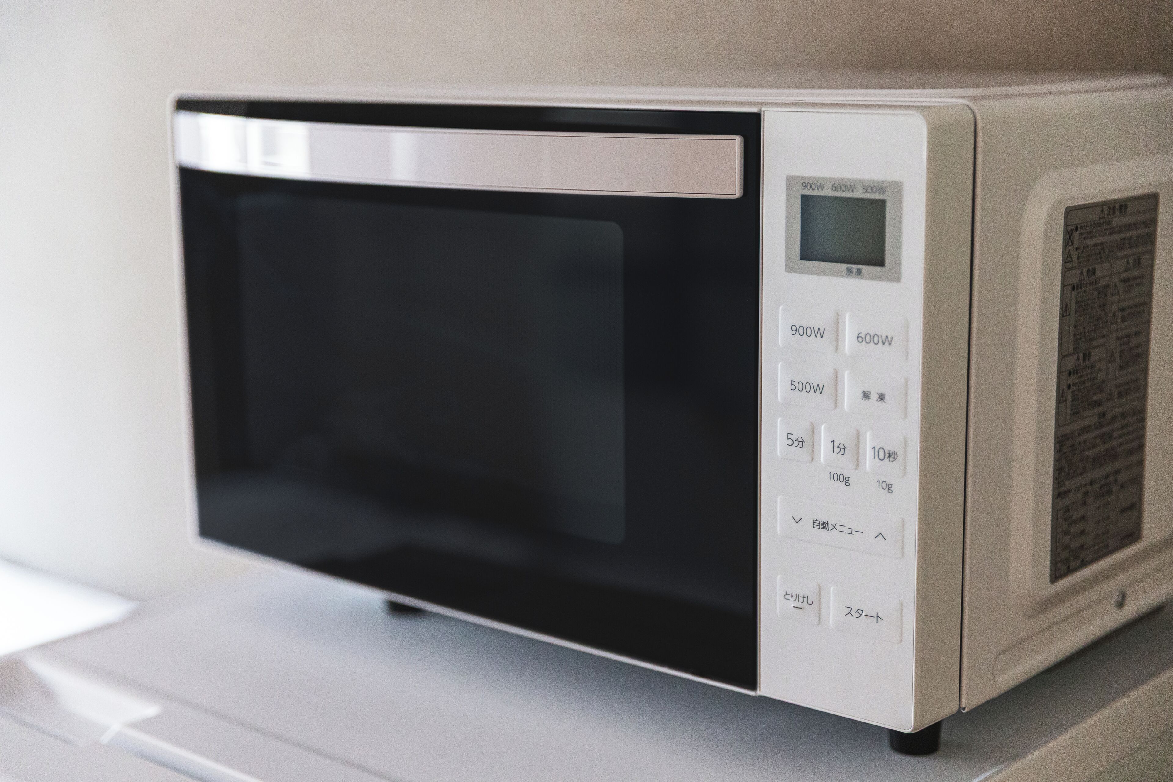 A microwave oven with a digital display and multiple power settings.