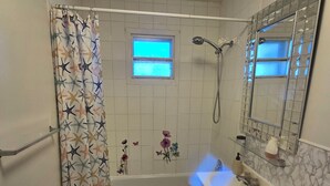 A bathroom with a shower, toilet, and sink. - brossard home inn 1 (Brossard)