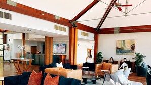 A spacious lobby with a high ceiling, wooden beams, a ceiling fan, and a reception desk. - Premium 2 Bedroom French Villa + Free Wine Tasting (Pokolbin)