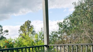 A white metal table with chairs on a wooden deck, a potted plant, and a railing. - Premium 2 Bedroom French Villa + Free Wine Tasting (Pokolbin)