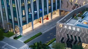 A modern hotel with a distinctive geometric facade, a well-maintained outdoor area, and clear signage. - Crystal Orange Hotel Shenzhen Bay MixC (Shenzhen)