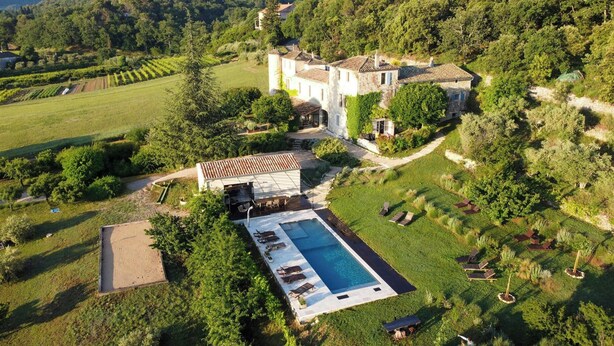 An aerial view of a large estate with a swimming pool, multiple buildings, and extensive greenery. - Former silk mill at the foot of Mont Ventoux (Crestet)