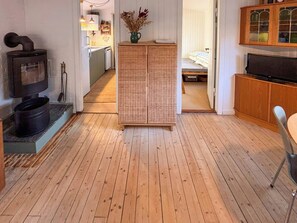 A compact living space with a kitchen, a dining area, and a bedroom.