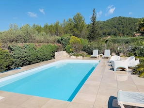A rectangular swimming pool with a tiled deck, surrounded by white lounge chairs and a variety of greenery. - SPACIOUS VILLA, TENNIS COURT, LARGE PARK (Cuers)
