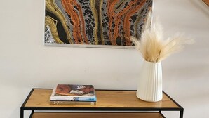 A wooden console table with a white vase and a book. - Bright Turner Apartment with Parking and WiFi (Turner)