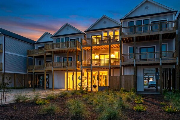 A multi-story hotel with balconies, a covered entrance, and a driveway.