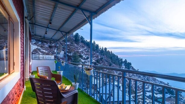 A balcony with a view of a snow-covered mountain range. - We are one paradise (Mussoorie)