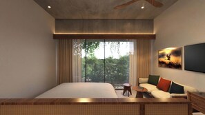Quarto moderno com cama grande, sofá, mesinha e televisão.