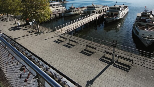 A waterfront promenade with boats docked, a pedestrian walkway, and a clear sky. - Apartment with balcony for max. 4 persons (Prien am Chiemsee)