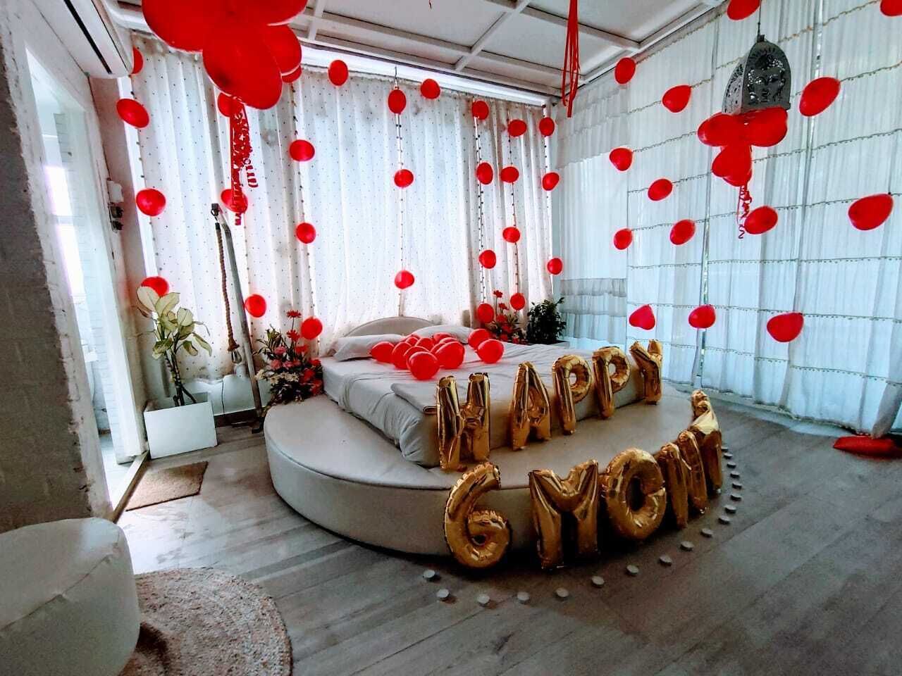 A circular bed with a mattress and pillows, surrounded by a white curtain.