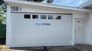 A white garage with the number 158 and the name 'VILLA STAHL' on the door. - 103 Apartment in Villa Stahl, Colonia Escalon (San Salvador)