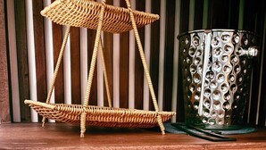 A wicker chair, a decorative metal pot, a green thermos, two teacups, and a sign with a WiFi passcode. - Mersey Residence Koh Samui (Koh Samui)